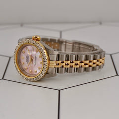 Close-up of pink mother-of-pearl dial on Rolex Datejust with diamonds